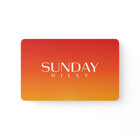Sunday Riley Gift Card - orange/red card with gold lines from bottom center with Sunday Riley logo in center