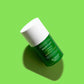 Martian Toner bottle lay down on green background with shadow
