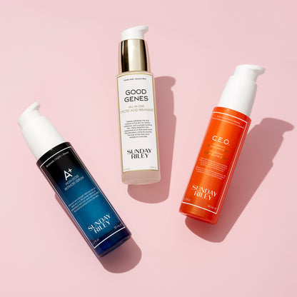 Good Genes, C.E.O. Serum and A+ bottles lay over a light pink background with shadow