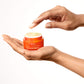 Hand model - one hand hold C.E.O. Vitamin C Cream jar and other hand reach to touch the light yellow goop