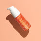 C.E.O. Vitamin C Serum bottle lay down on a peach background with shadow