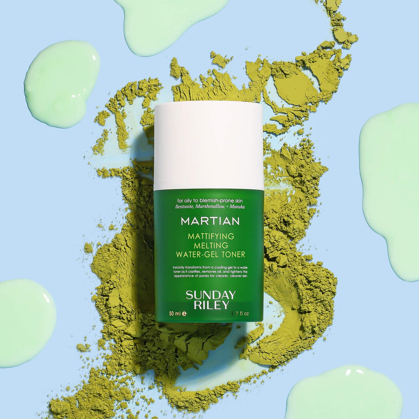 Martian Toner bottle on green tea powder with gree goop on a light blue background