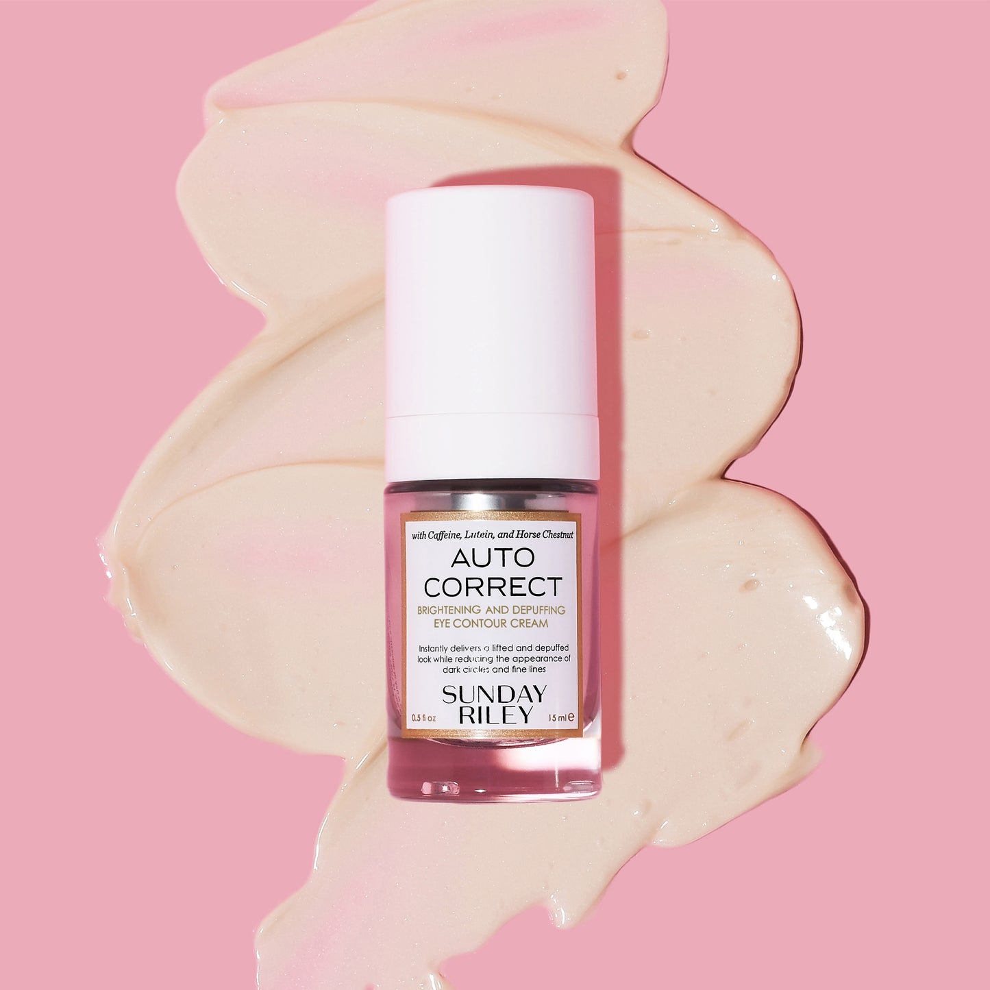 Auto Correct bottle lay down on goop with pink background